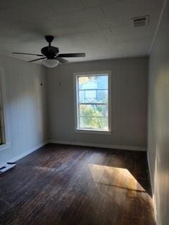 empty room with dark hardwood / wood-style flooring and ceiling fan