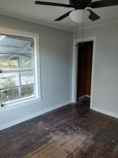 empty room featuring crown molding, dark hardwood / wood-style floors, and ceiling fan