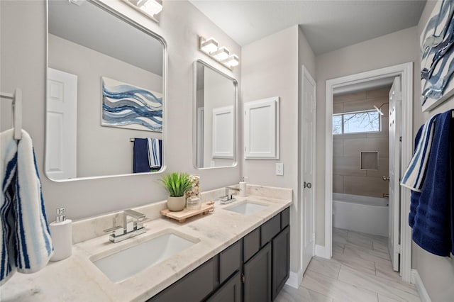 bathroom with vanity and tiled shower / bath