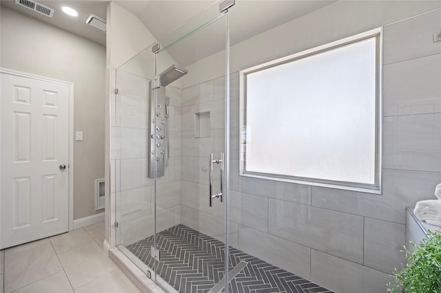 bathroom with tile patterned flooring and an enclosed shower