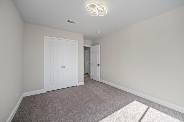 unfurnished bedroom with a closet and carpet