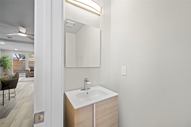 bathroom featuring ceiling fan, vanity, and hardwood / wood-style floors