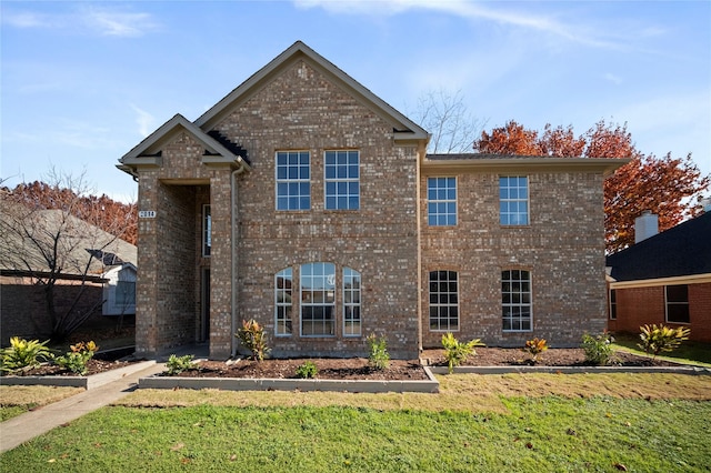 front facade with a front yard