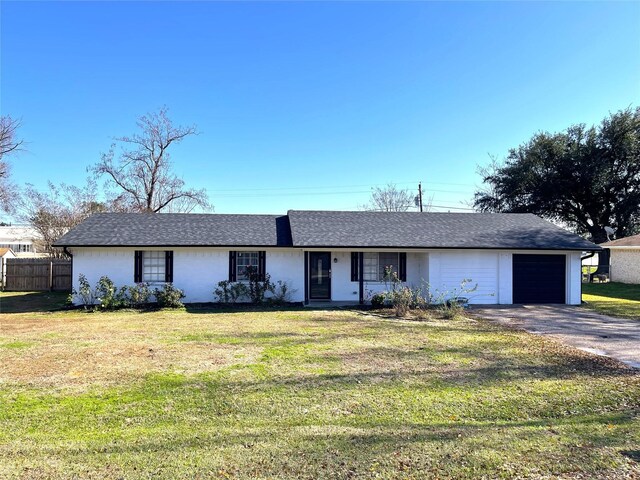 single story home with a front yard and a garage