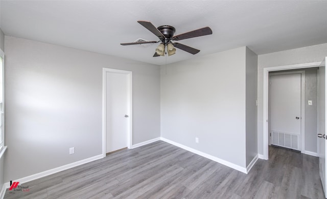 empty room with hardwood / wood-style floors and ceiling fan