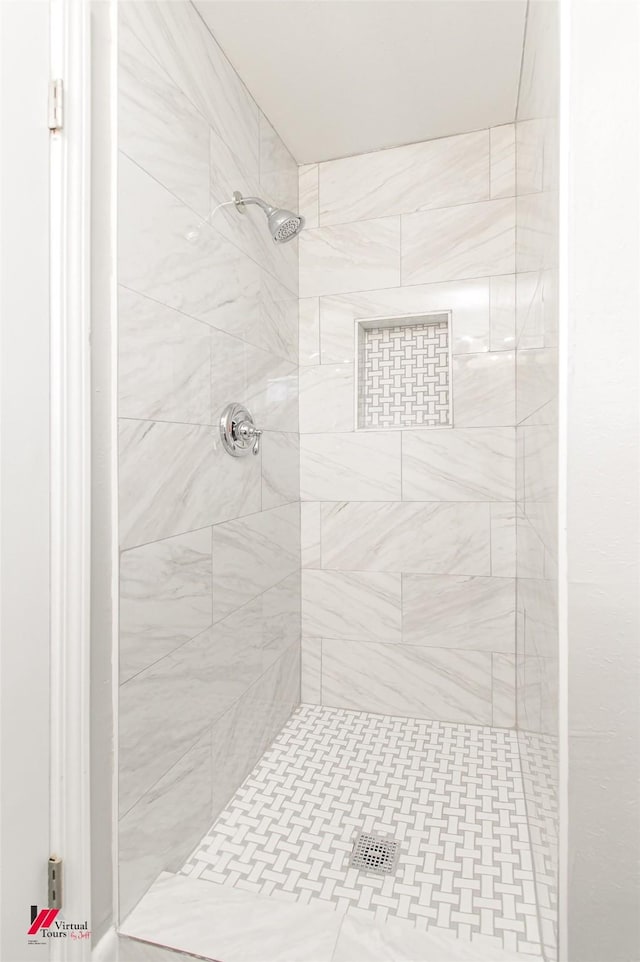 bathroom with tiled shower