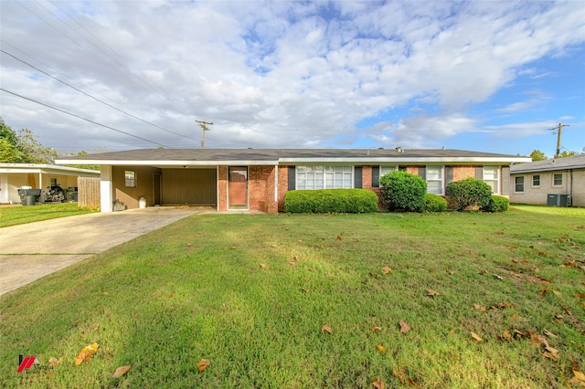 ranch-style house featuring a front lawn, central AC, and a carport