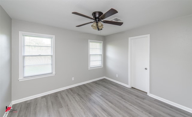 unfurnished room with ceiling fan, light hardwood / wood-style flooring, and a healthy amount of sunlight