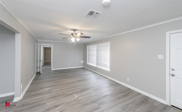 empty room featuring crown molding, ceiling fan, and light hardwood / wood-style floors