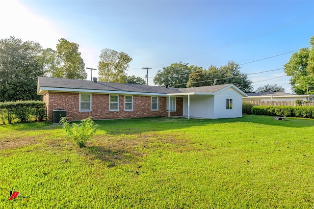 view of front of property with a front lawn and cooling unit