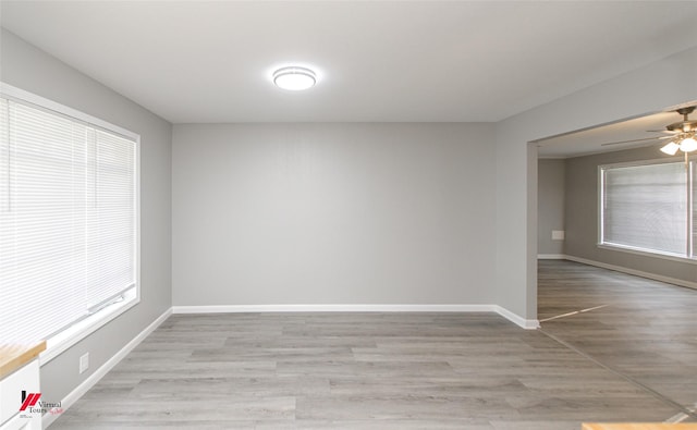 empty room featuring light hardwood / wood-style flooring, plenty of natural light, and ceiling fan