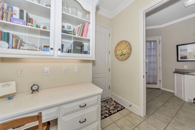 interior space with crown molding and light tile patterned floors