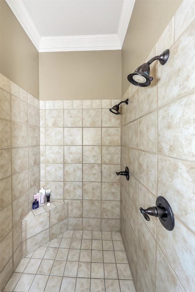 bathroom with crown molding and tiled shower