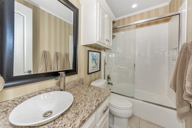 full bathroom featuring enclosed tub / shower combo, vanity, ornamental molding, tile patterned floors, and toilet