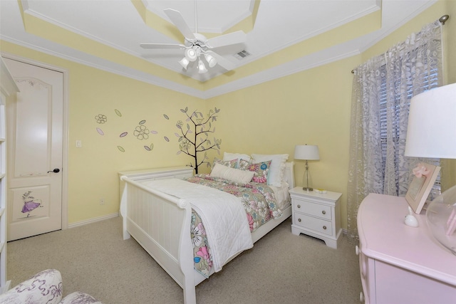 bedroom with a tray ceiling, light colored carpet, and ceiling fan