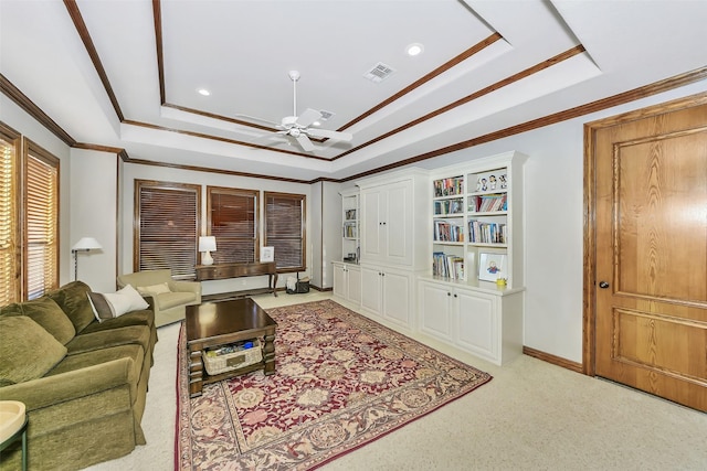 living room with light carpet, ornamental molding, a raised ceiling, and ceiling fan