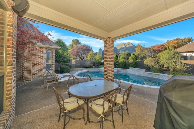 view of patio / terrace with a fenced in pool and a grill