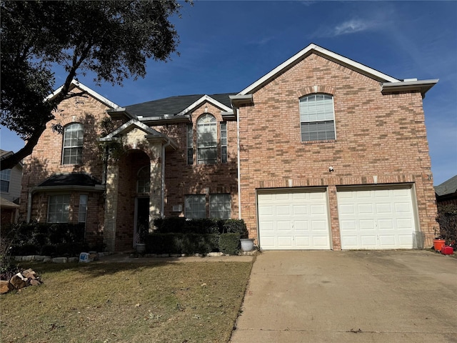 view of front facade with a garage and a front lawn