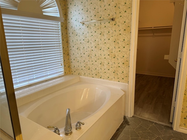 bathroom featuring tile patterned flooring and a tub