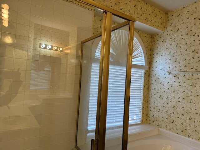 bathroom with shower with separate bathtub