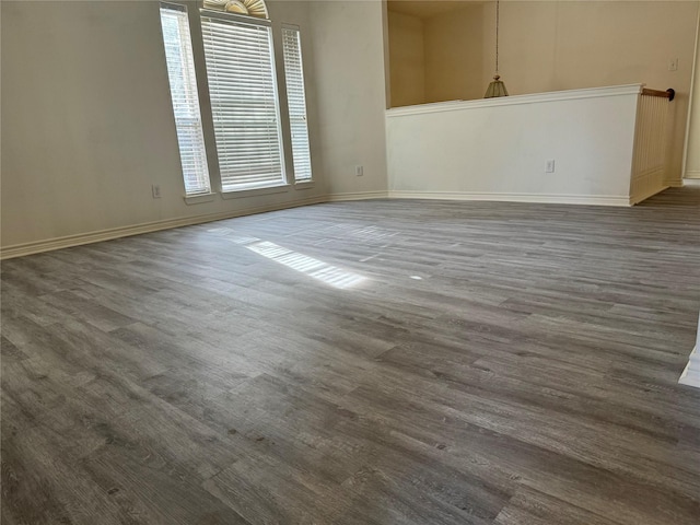 unfurnished room with dark hardwood / wood-style flooring