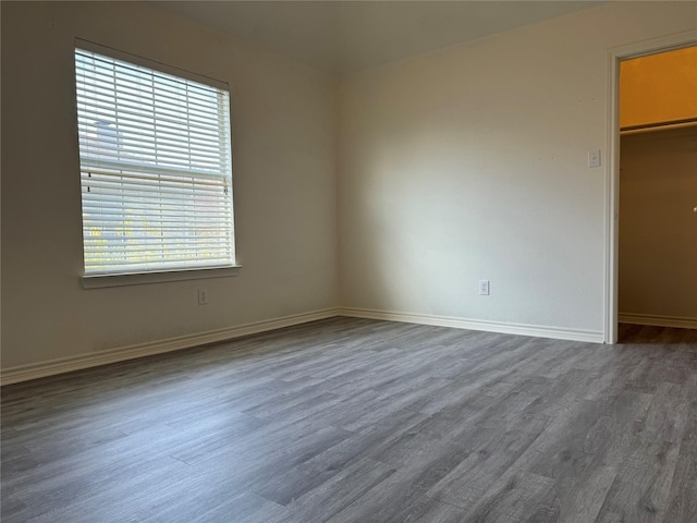 spare room with dark hardwood / wood-style floors