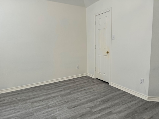 spare room with dark hardwood / wood-style flooring