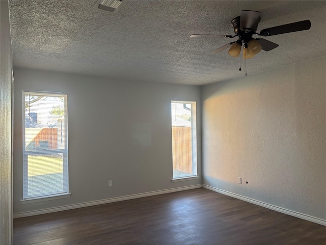 unfurnished room featuring a textured ceiling and dark wood-type flooring