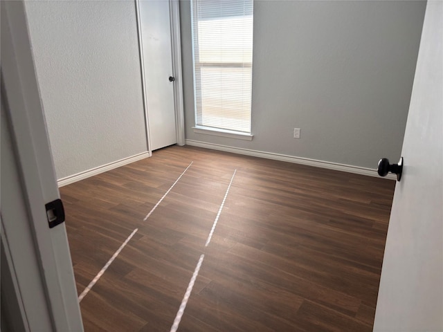 unfurnished room featuring dark hardwood / wood-style flooring