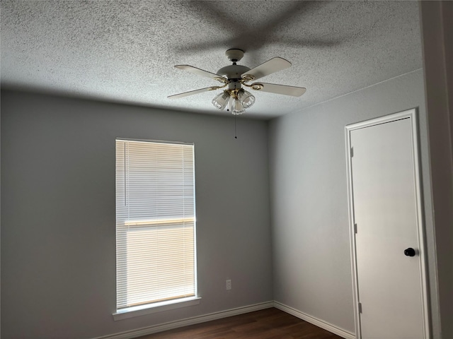 spare room featuring a textured ceiling, dark hardwood / wood-style flooring, and ceiling fan