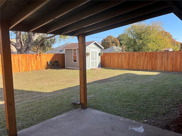 view of yard with a shed and a patio area