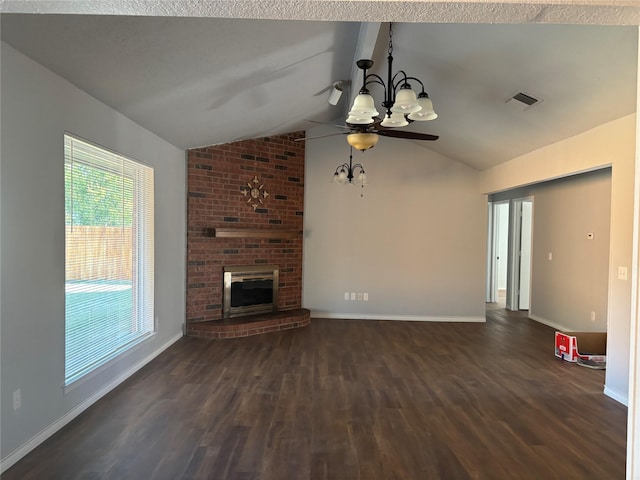 unfurnished living room with ceiling fan with notable chandelier, dark wood-type flooring, lofted ceiling, and a brick fireplace