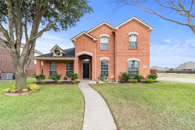 view of front facade featuring a front yard and central AC unit