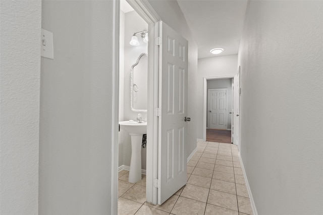 corridor featuring light tile patterned floors