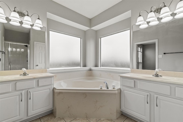 bathroom with tile patterned floors, vanity, and separate shower and tub