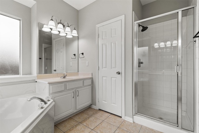 bathroom with tile patterned floors, vanity, and separate shower and tub