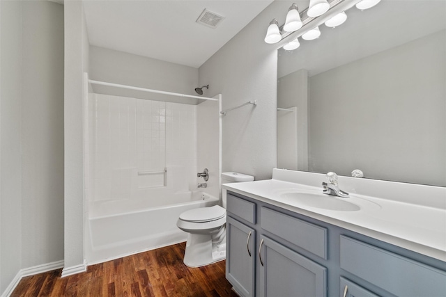 full bathroom with toilet, vanity,  shower combination, and hardwood / wood-style flooring