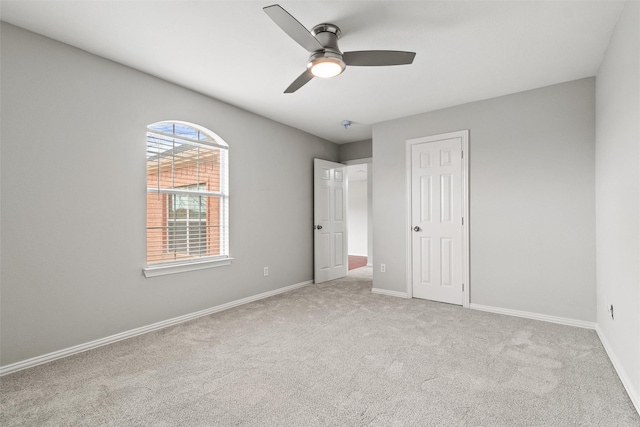 unfurnished bedroom featuring ceiling fan and light carpet