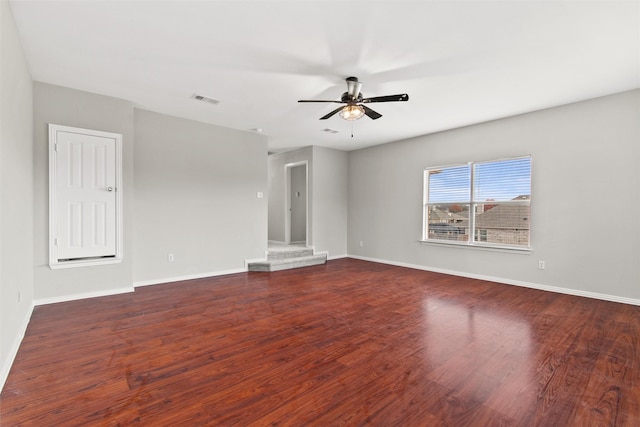 empty room featuring ceiling fan and dark hardwood / wood-style flooring