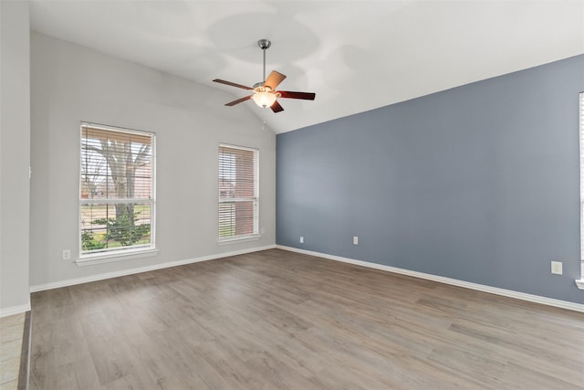 empty room with light wood-type flooring, vaulted ceiling, and ceiling fan