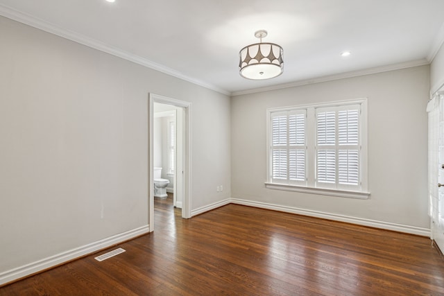 empty room featuring dark hardwood / wood-style flooring and ornamental molding