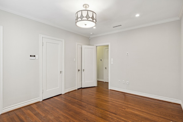 spare room featuring dark hardwood / wood-style flooring and ornamental molding