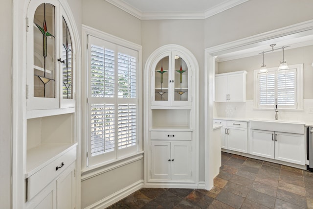 unfurnished dining area with plenty of natural light, ornamental molding, and sink