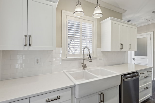 kitchen featuring sink, tasteful backsplash, crown molding, pendant lighting, and white cabinets