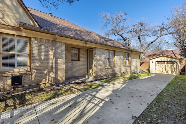 view of property exterior featuring a garage and an outbuilding