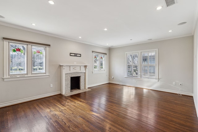 unfurnished living room with a wealth of natural light, ornamental molding, dark wood-type flooring, and a brick fireplace