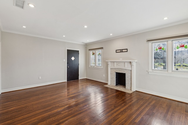 unfurnished living room with crown molding, dark wood-type flooring, and a brick fireplace