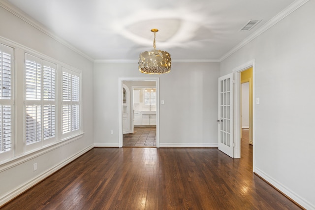 interior space featuring crown molding, dark hardwood / wood-style flooring, and a notable chandelier