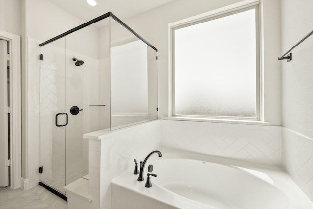 bathroom featuring a bath and a stall shower