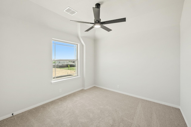 empty room featuring baseboards, visible vents, light colored carpet, and a ceiling fan
